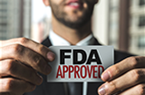 man holding a card that says FDA approved